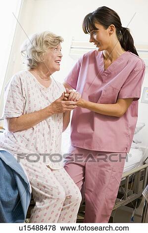 Nurse Helping Senior Woman To Walk View Large Photo Image Stock Photo - Nurse Helping Senior Woman To Walk. Fotosearch
