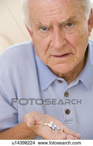 Senior Man Holding Prescription Drugs View Large Photo Image Picture - Senior Man Holding Prescription Drugs. Fotosearch