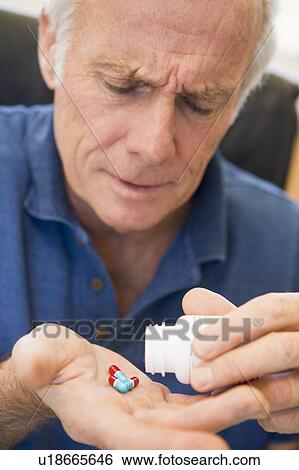 Senior Man Pouring Pills Out Of Bottle View Large Photo Image Stock Photograph - Senior Man Pouring Pills Out Of Bottle. Fotosearch