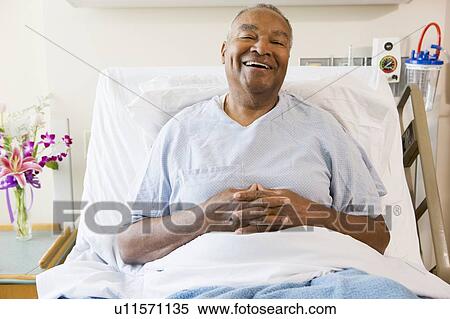 Stock Photography - Senior Man Sitting In Hospital Bed, Smiling. Fotosearch