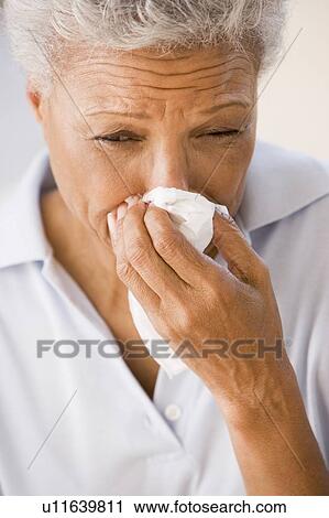 Stock Image - Woman Blowing Her Nose. Fotosearch