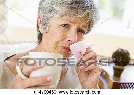 Stock Image - Woman Blowing Her Nose. Fotosearch