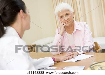 Woman in doctor's office frowning View Large Photo Image Stock Photo - Woman in doctor's office frowning. Fotosearch