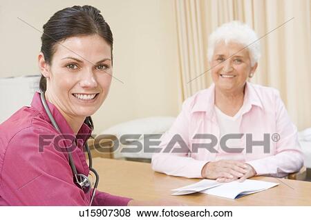 Stock Photo - Woman in doctor's office smiling. Fotosearch