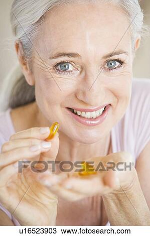 Stock Image - Woman Taking Pills. Fotosearch