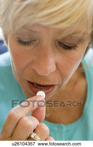 Stock Photo - Woman Taking Pills. Fotosearch