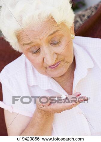 Stock Photograph - Woman Taking Pills. Fotosearch