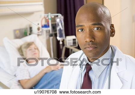 Stock Photo - Doctor Looking Serious In Hospital Room, Senior Woman Lying In Hospital Bed. Fotosearch