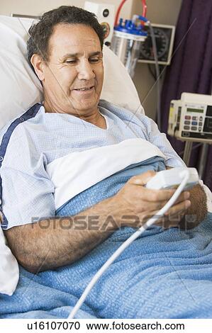 Middle Aged Man Pressing The Call Button In Hospital View Large Photo Image Stock Image - Middle Aged Man Pressing The Call Button In Hospital. Fotosearch