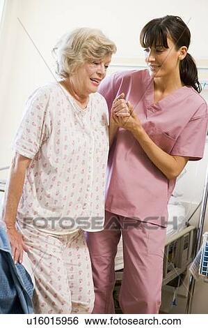 Stock Photograph - Nurse Helping Senior Woman To Walk. Fotosearch