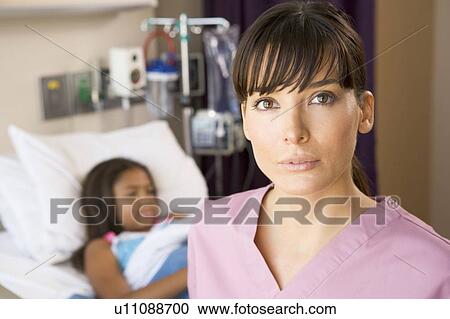 Stock Image - Nurse Standing In Hospital Room. Fotosearch