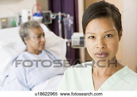 Nurse Standing In Patients Room Looking Serious View Large Photo Image Stock Photography - Nurse Standing In Patients Room Looking Serious. Fotosearch