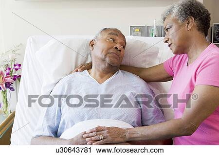 Stock Image - Senior Couple Looking Serious In Hospital. Fotosearch