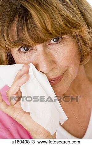 Stock Image - Woman Blowing Her Nose. Fotosearch