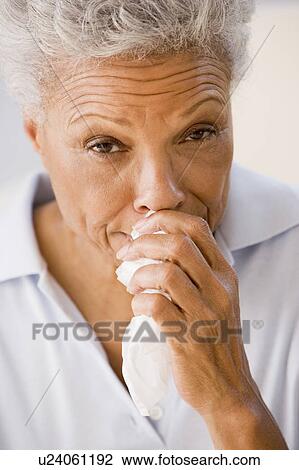 Stock Image - Woman Blowing Her Nose. Fotosearch