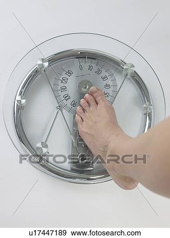 Woman on a bathroom scale, feet View Large Photo Image Stock Photo - Woman on a bathroom scale, feet. Fotosearch