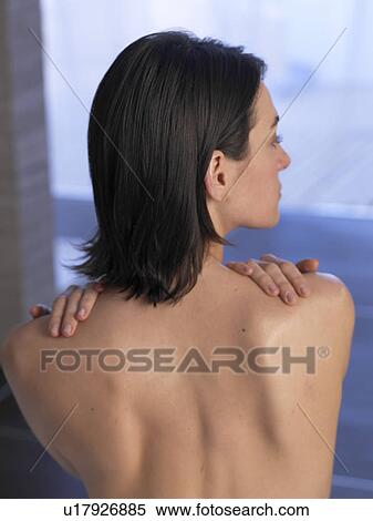 Woman sitting on massage table, backview View Large Photo Image Stock Photography - Woman sitting on massage table, backview. Fotosearch