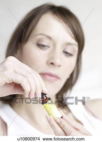 Woman with bach flower remedies rescue drops View Large Photo Image Picture - Woman with bach flower remedies rescue drops. Fotosearch