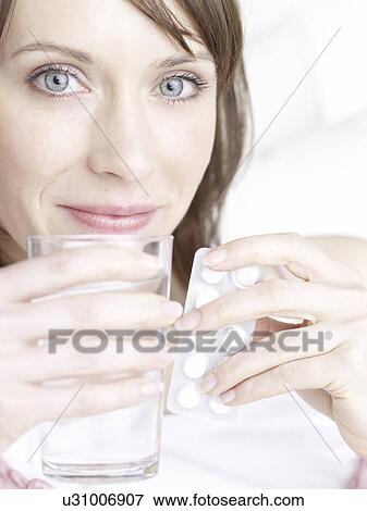 Woman with glass of water and pills View Large Photo Image Stock Photo - Woman with glass of water and pills. Fotosearch