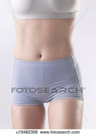 Stock Photo - Woman with sportswear, belly. Fotosearch