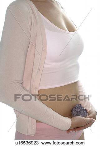 Woman with amethsyte in front f her belly View Large Photo Image Stock Image - Woman with amethsyte in front f her belly. Fotosearch