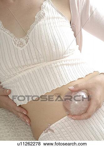 Woman with rose quartz on her belly View Large Photo Image Stock Photo - Woman with rose quartz on her belly. Fotosearch