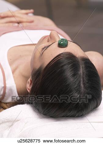 Stock Photography - Young woman with malachite on her front. Fotosearch