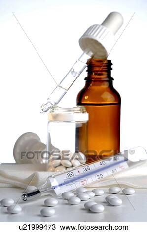 Stock Image - Homeopathic remedies and clinical thermometer. Fotosearch