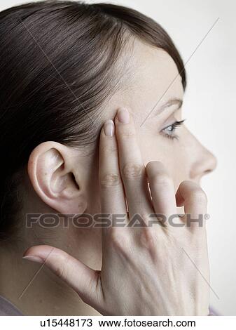 Stock Image - massage at the temples. Fotosearch