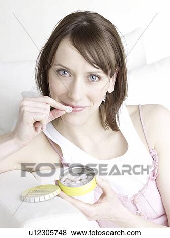 Stock Photo - Woman taking rescue pills. Fotosearch