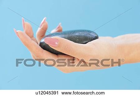 Clip Art - Stone in a woman's hand. Fotosearch