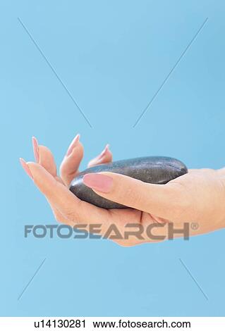 Clip Art - Stone in a woman's hand. Fotosearch