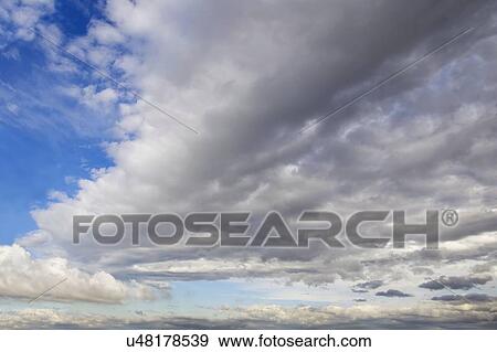 Stock Illustration - Blue sky with cumulus clouds, artwork. Fotosearch
