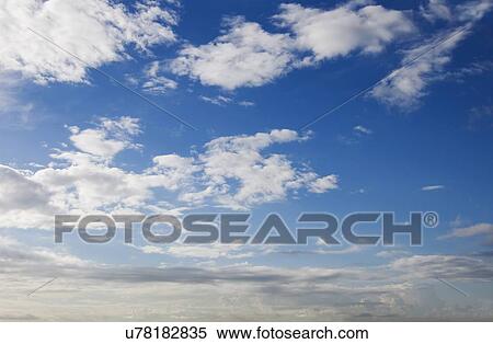 Stock Illustration - Blue sky with cumulus clouds, artwork. Fotosearch