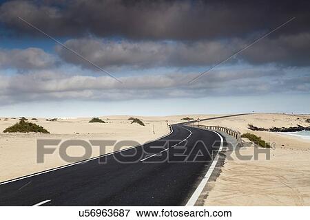 Stock Illustration - Road through sand dunes, Canary Islands. Fotosearch