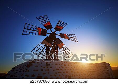Stock Illustration - Windmill at sunset. Fotosearch