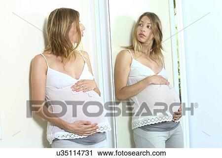 Clip Art - Pregnant woman and reflection. Fotosearch