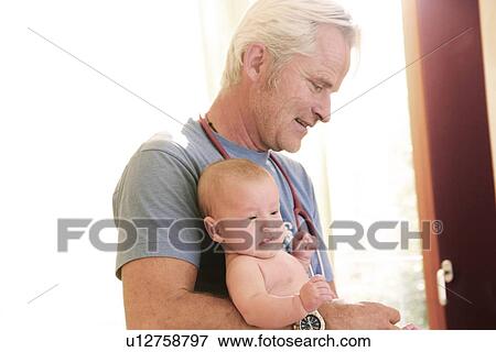 Stock Illustration - Doctor holding baby. Fotosearch