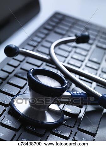 Clipart - Stethoscope on keyboard. Fotosearch