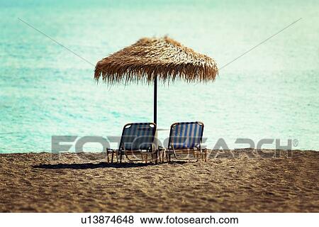 Stock Illustration - Sunloungers and parasol. Fotosearch