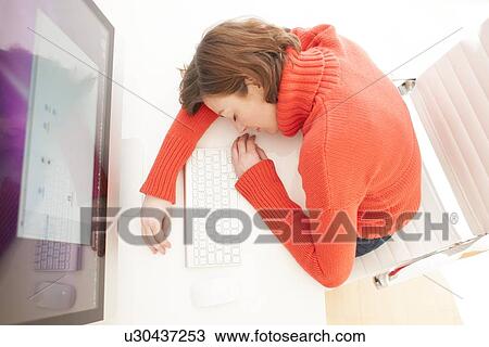 Drawing - Woman asleep on keyboard. Fotosearch