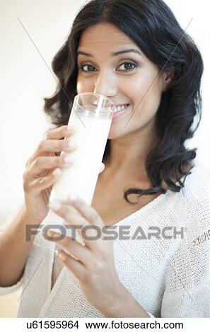 Stock Illustration - Woman drinking milk. Fotosearch