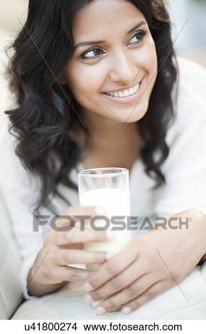 Stock Illustration - Woman holding milk. Fotosearch