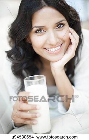 Woman holding milk View Large Illustration Stock Illustration - Woman holding milk. Fotosearch