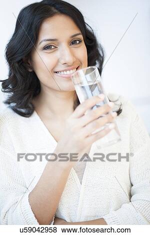 Stock Illustration - Woman holding water. Fotosearch