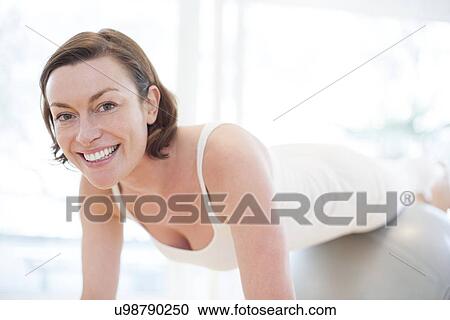 Clipart - Woman on exercise ball. Fotosearch