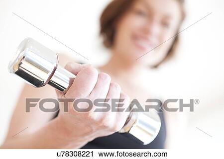 Clip Art - Woman using hand weight. Fotosearch
