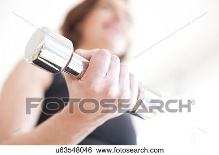 Stock Illustration - Woman using hand weight. Fotosearch