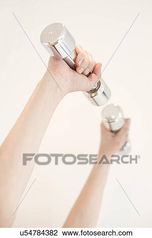 Drawing - Woman using hand weights. Fotosearch