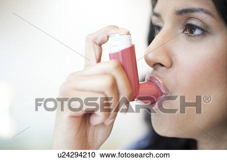 Clipart - Woman using inhaler. Fotosearch